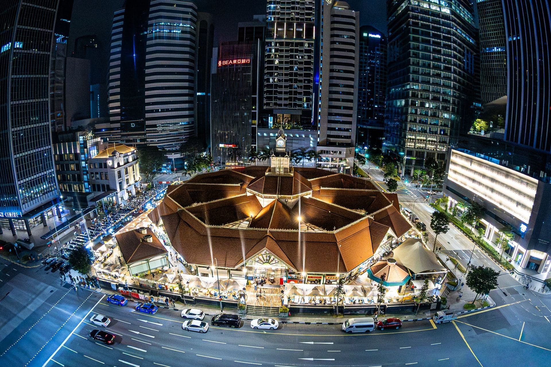 Lau Pa Sat surrounded by Singapore’s illuminated financial district